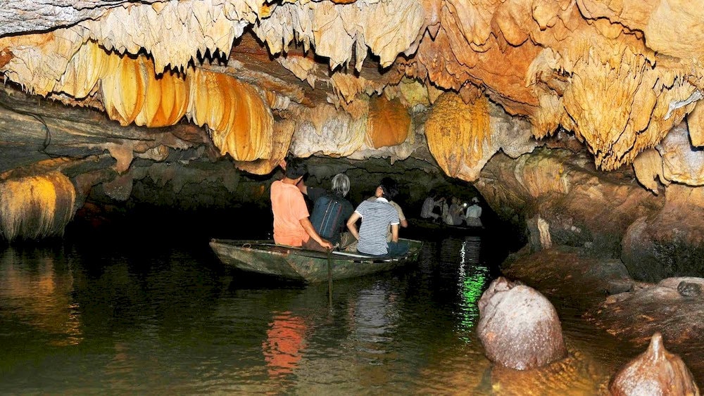 The stalactites hang from the cave ceiling, resembling frozen waterfalls sculpted by time and nature 